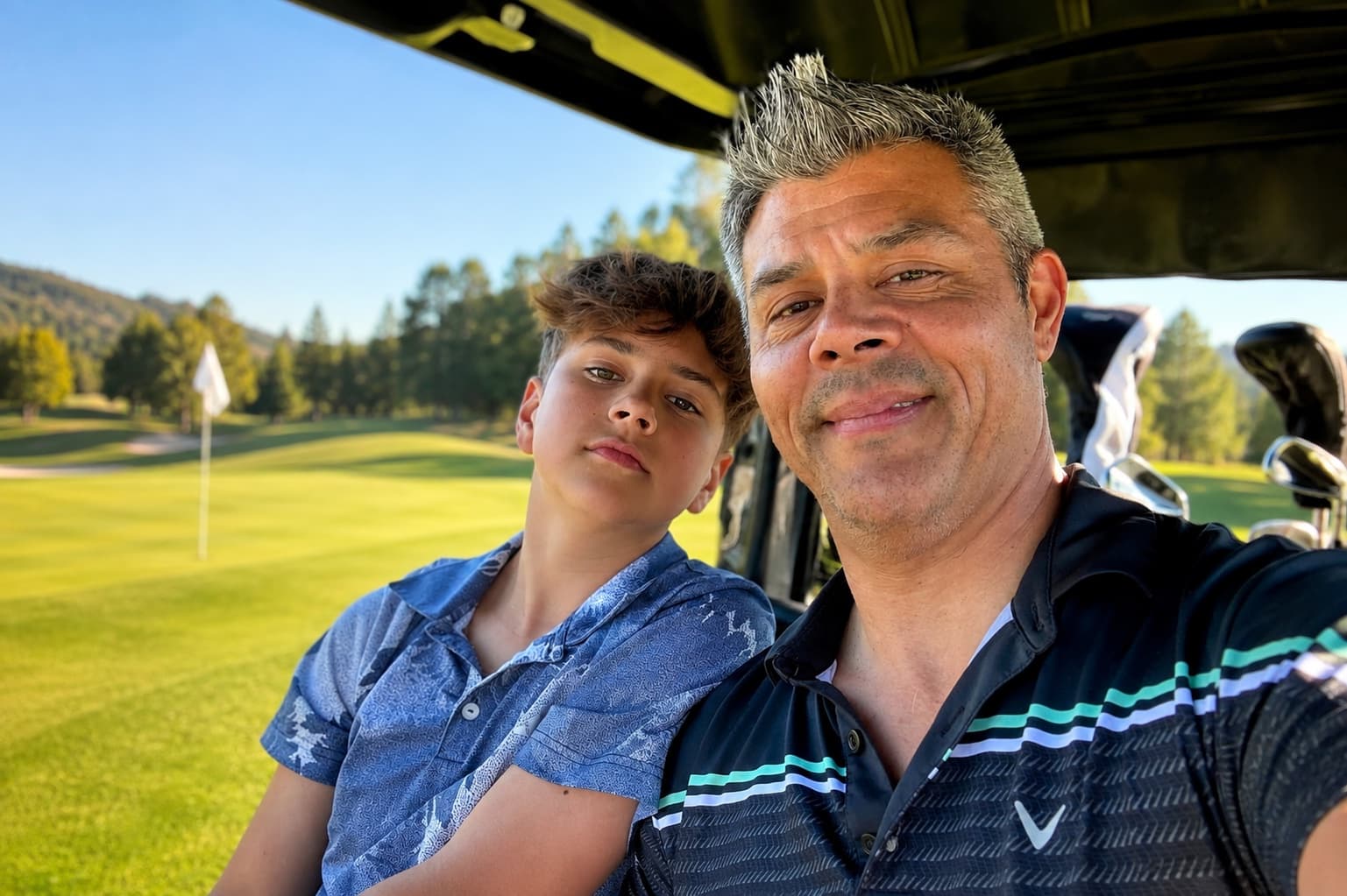 Shawn Sakura and his son Jameson together on a golf course